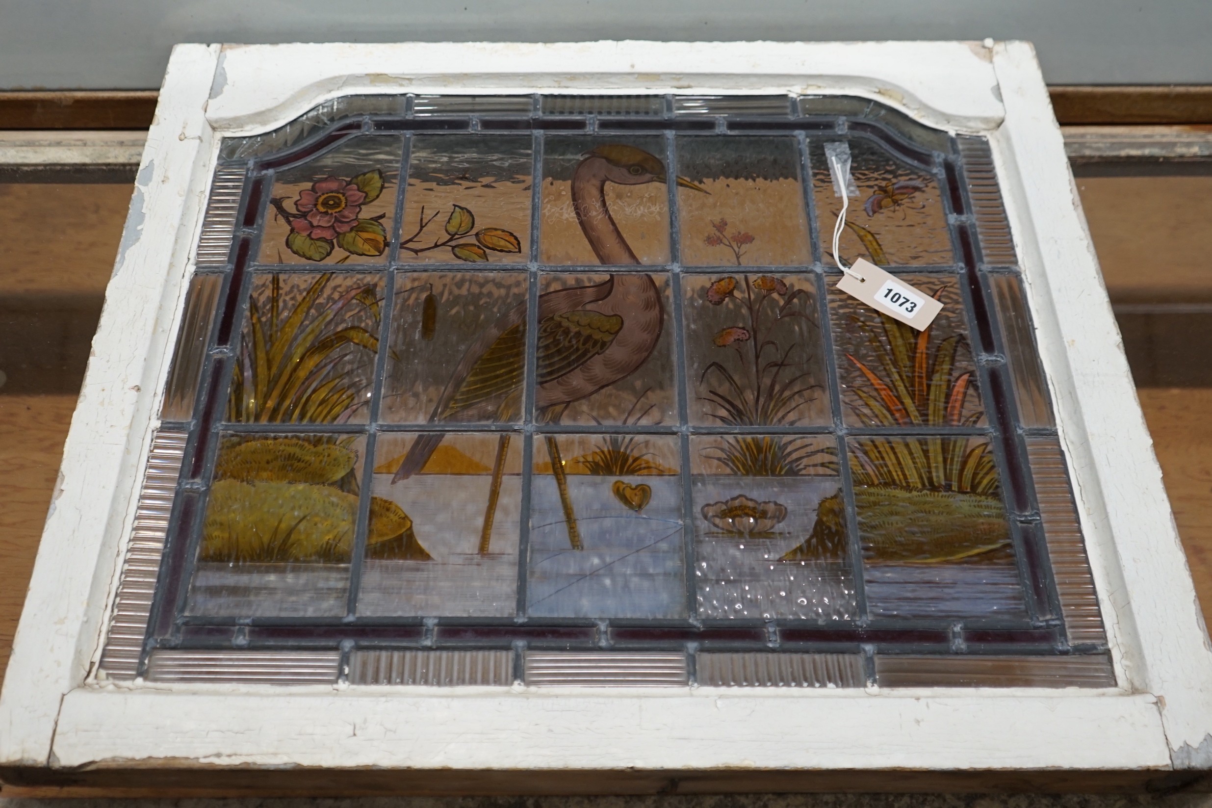 A late Victorian stained leaded glass panel depicting a heron amongst reeds, width 71cm, height 61cm